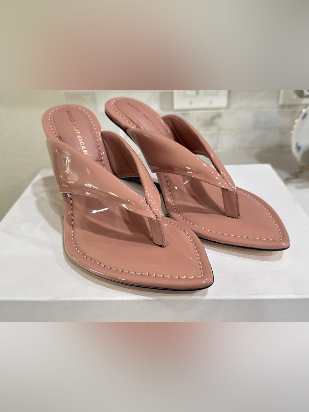 Good American "Cinderella" Clear Wedge Thong Sandals in the shade Dusty Pink.